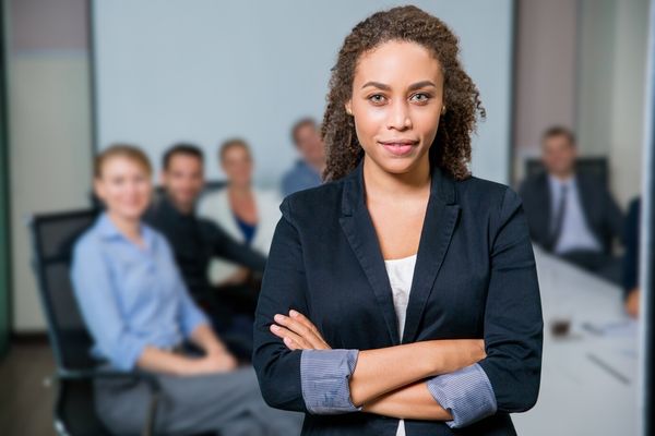 Picture of a small team in a meeting with a strong leader at the front.